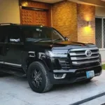 Luxury black Toyota Land Cruiser parked outside a modern house available as Toyota land Cruiser for rent for premium travel and VIP transport services in Pakistan.
